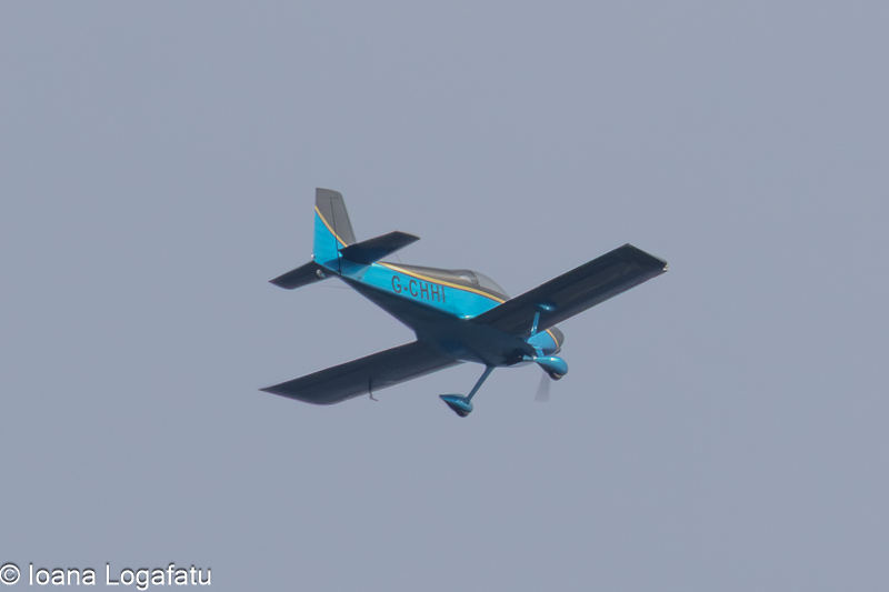 Cloudy skies highlight a plane soaring above